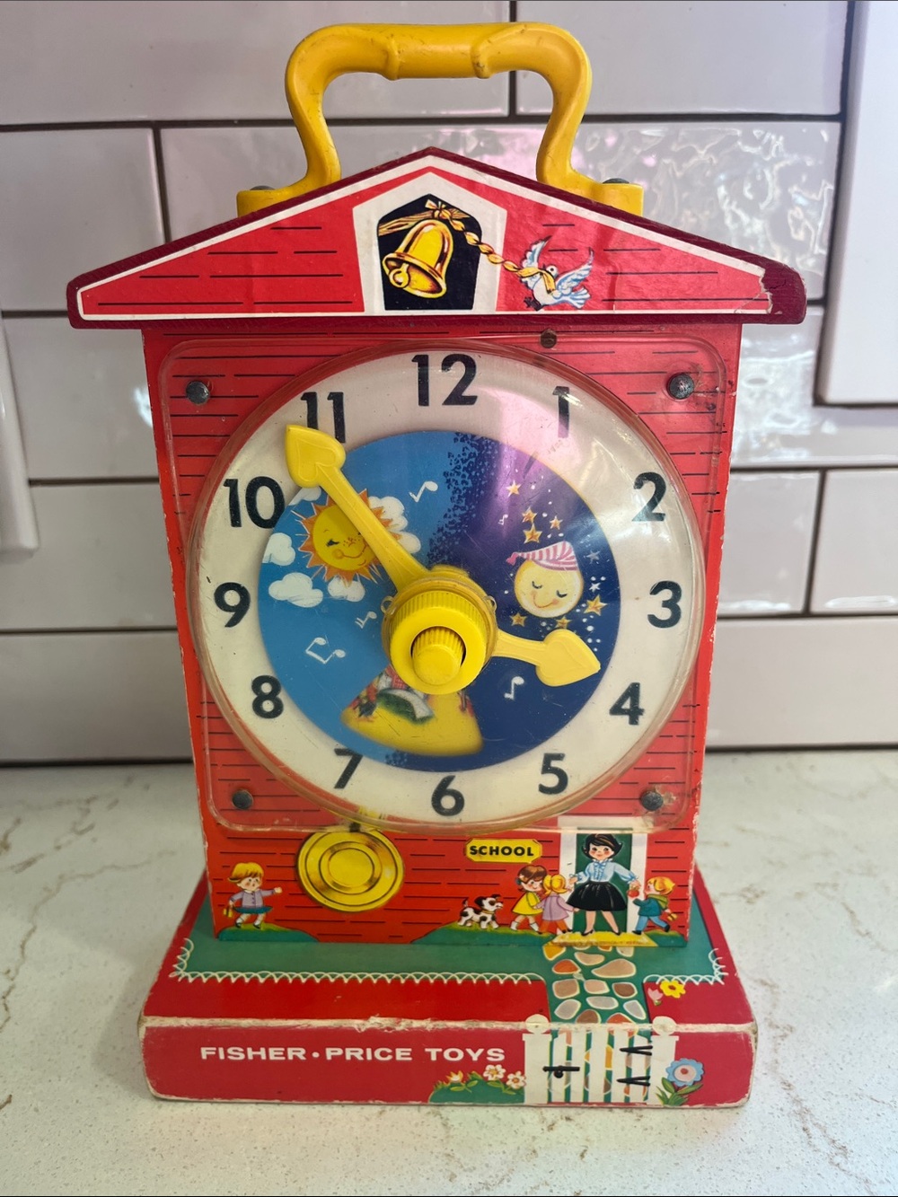 Fisher-Price Red Schoolhouse Clock Toy with Yellow Handle and Dial Hands